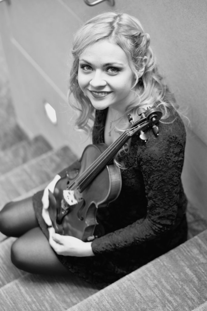 Headshot of Holly Workman with a violin