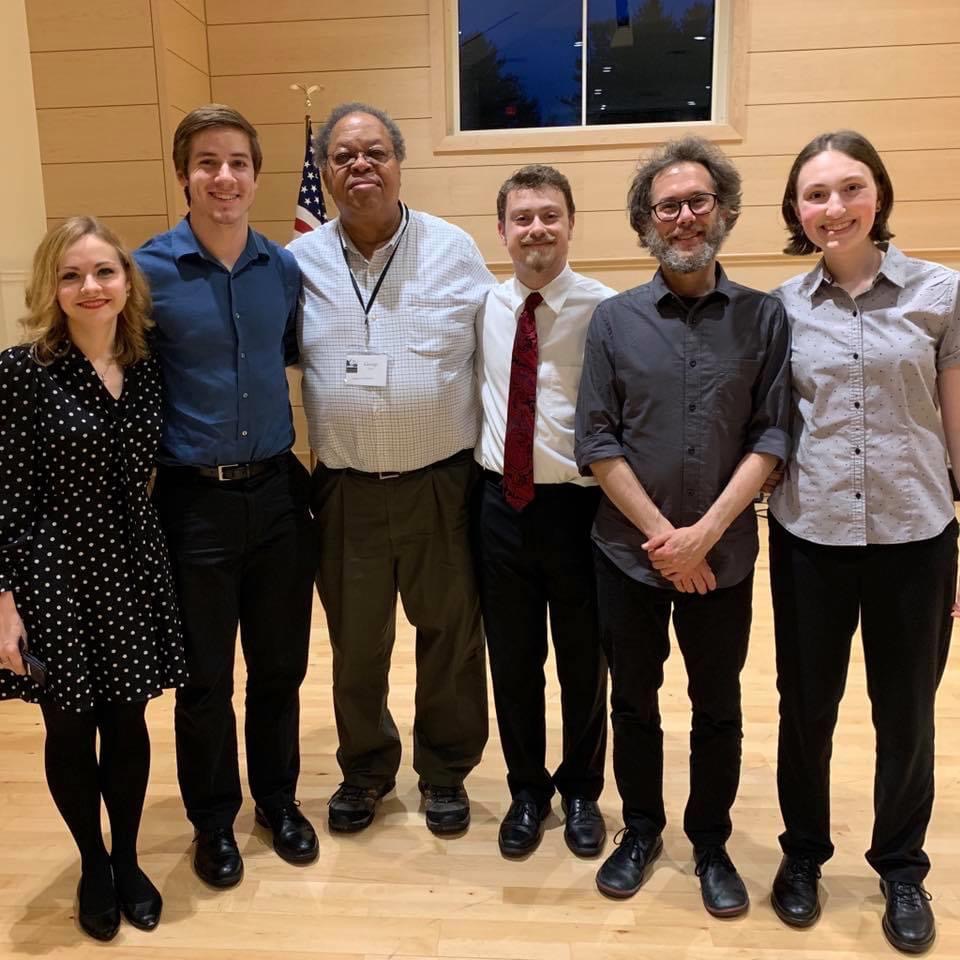 Violinist Holly Workman smiling after a concert with composer George Lewis and four other musicians