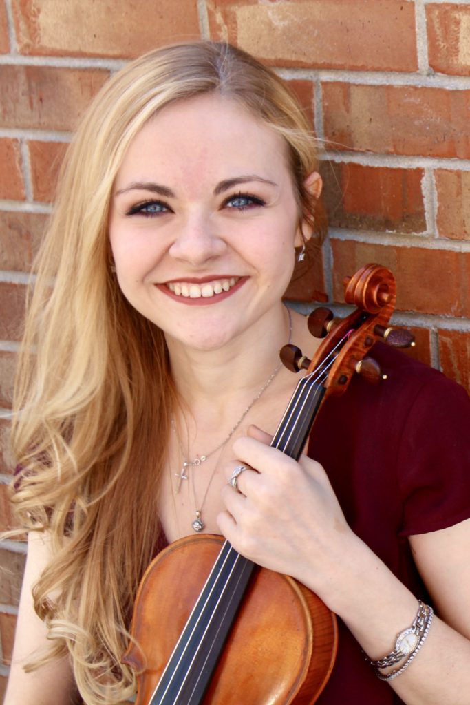 Holly Workman holding a violin, professional headshot